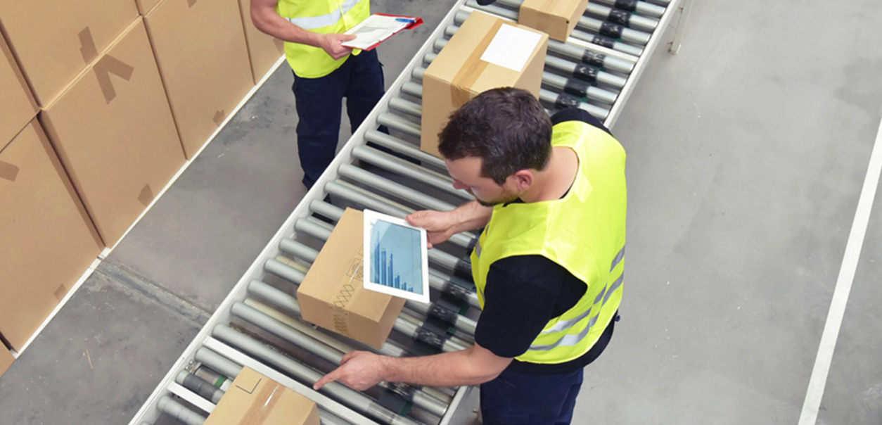 man checking parcels on iPad