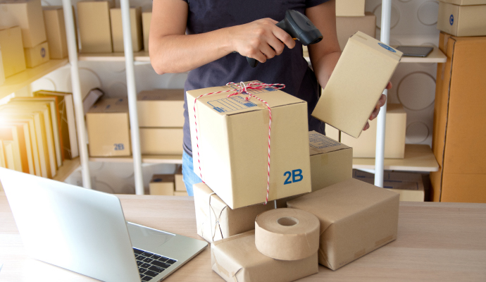 man scanning parcels in his office