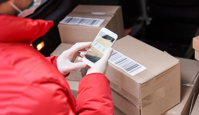 delivery man scanning parcels whilst out on delivery